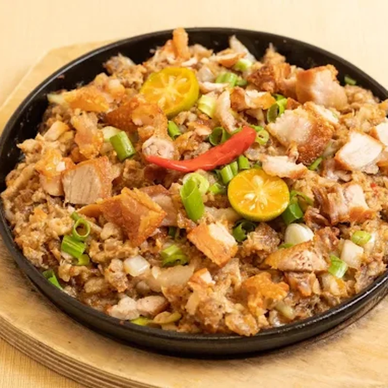 Family-style Filipino pancit noodles packed for takeout at Mar's Sisig Winnipeg